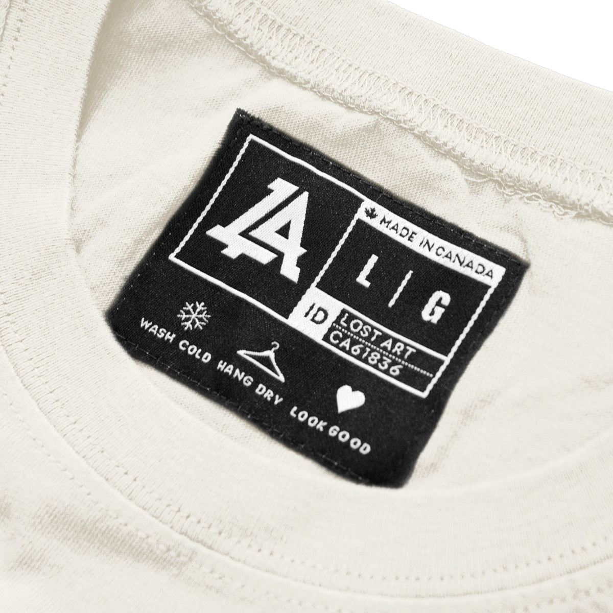 Lost Art Canada - brown orange print on natural eco lost art coffee donut tee inside tag view