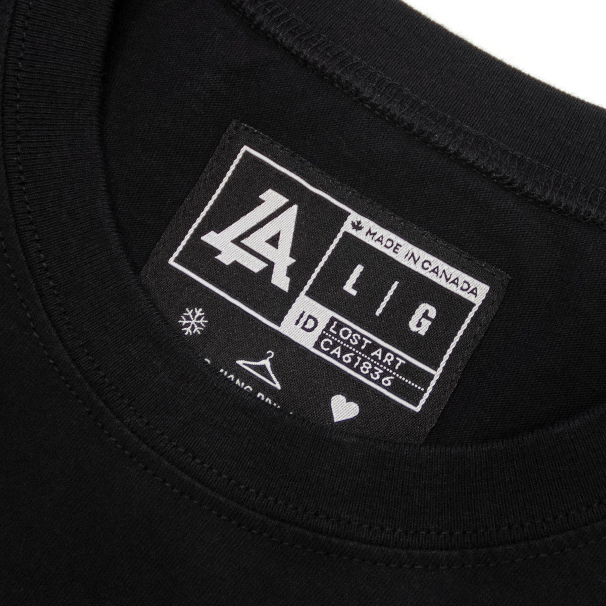 Lost Art Canada - white on black lost art icon logo tee inside tag view